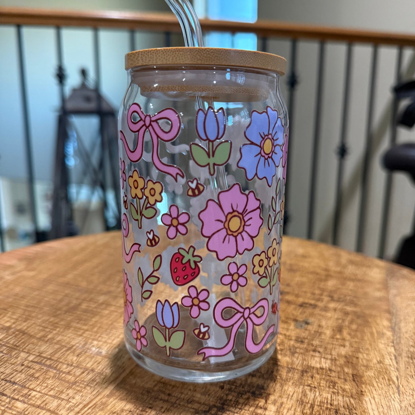 Tumbler with floral designs on a wooden surface